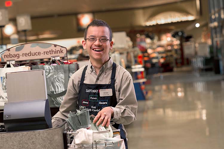 A man with developmental disability working in a grocery store.